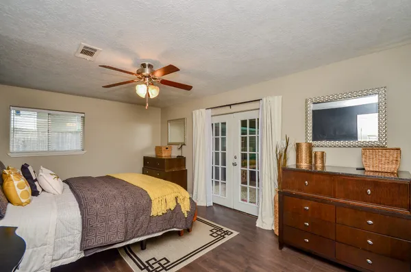 a bedroom with a bed and a flat screen tv