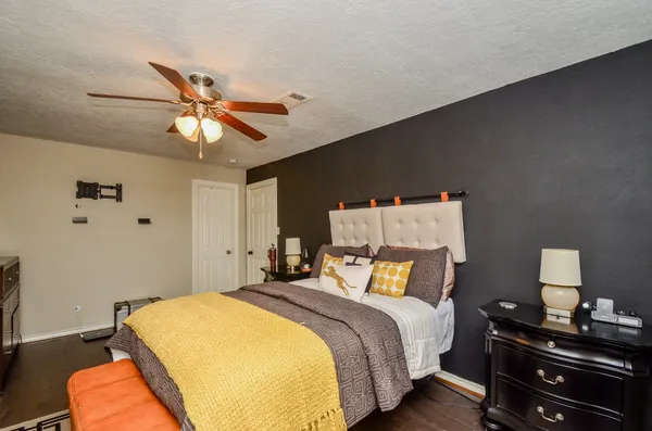 a bedroom with a bed and a chandelier