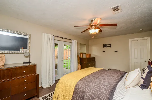 a bedroom with a bed and a flat screen tv