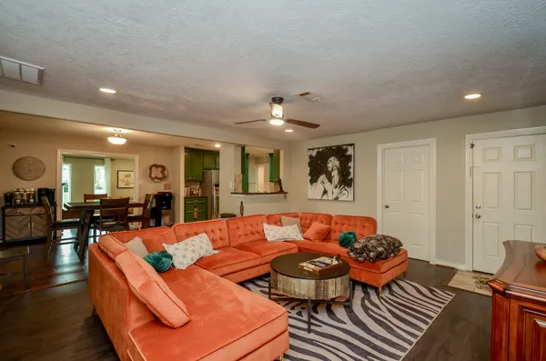 a living room with furniture and wooden floor