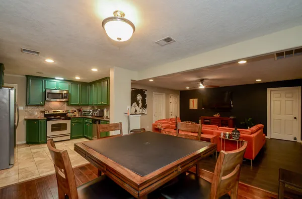 a large kitchen with a table and chairs