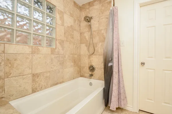 a bathroom with a bathtub and shower