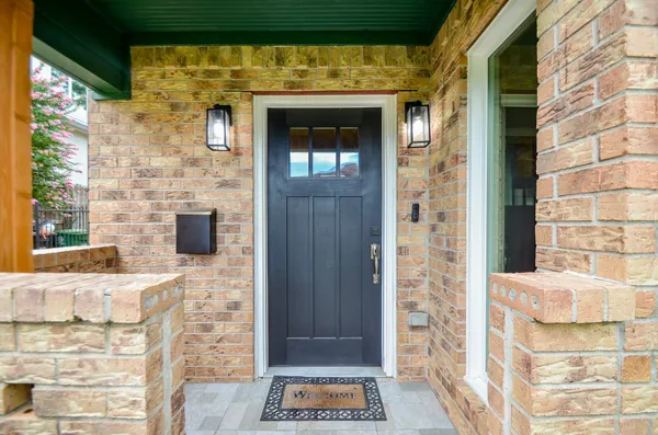 a view of front door of house with a potted plant
