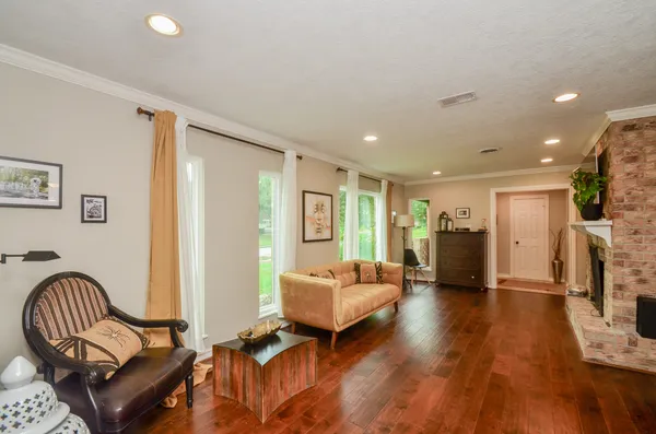 a living room with furniture and a wooden floor