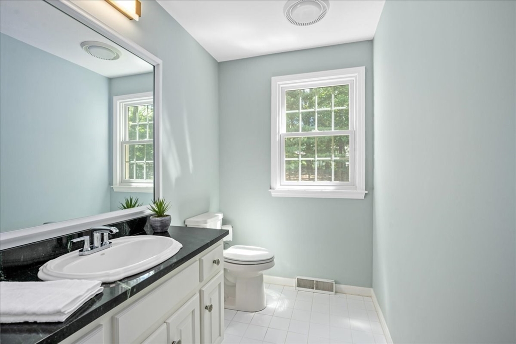 4 Round Table Road Shrewsbury, MA 01545 - Photo 16 of 41 a bathroom with a granite countertop sink a toilet and a window