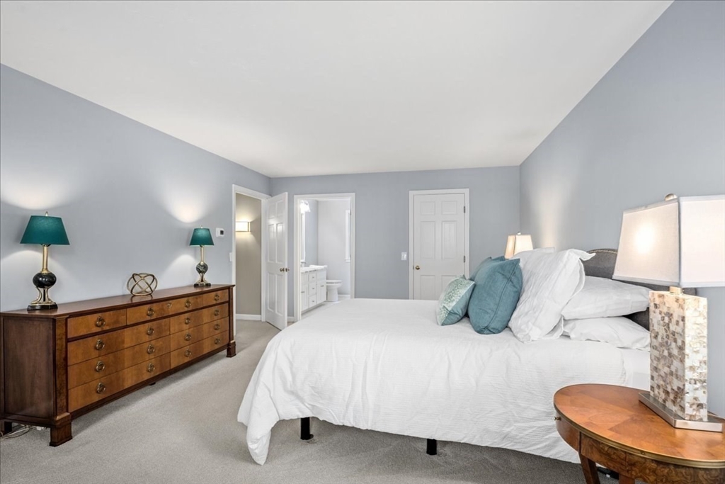 4 Round Table Road Shrewsbury, MA 01545 - Photo 21 of 41 a bedroom with a bed and dresser with mirror