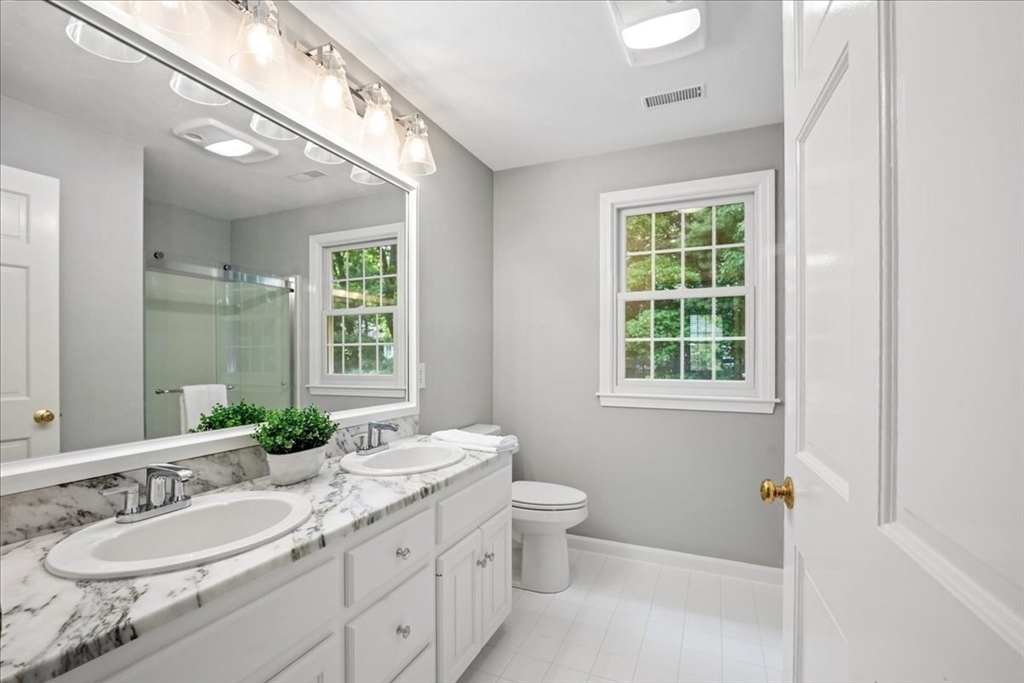 4 Round Table Road Shrewsbury, MA 01545 - Photo 22 of 41 a bathroom with a granite countertop double vanity sink a mirror and a window
