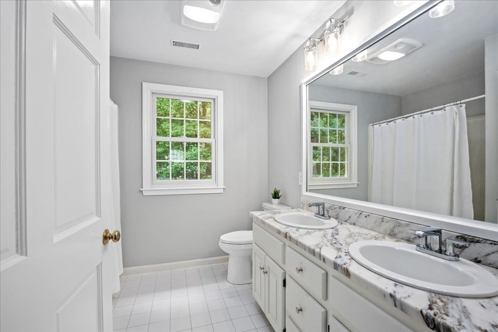 4 Round Table Road Shrewsbury, MA 01545 - Photo 26 of 41 a bathroom with a granite countertop double vanity sink a mirror and a toilet