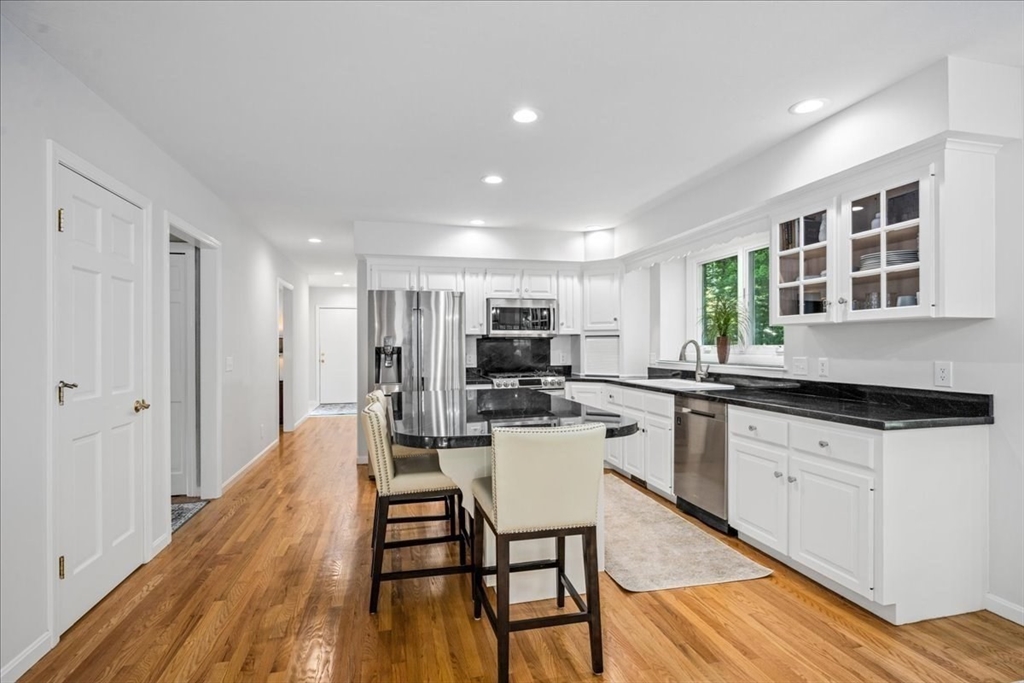 4 Round Table Road Shrewsbury, MA 01545 - Photo 5 of 41 a kitchen with granite countertop white cabinets and chairs