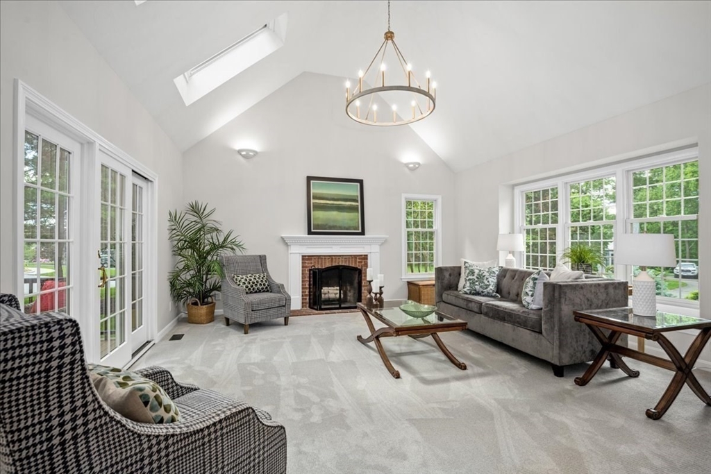 4 Round Table Road Shrewsbury, MA 01545 - Photo 10 of 41 a living room with furniture chandelier and a fireplace