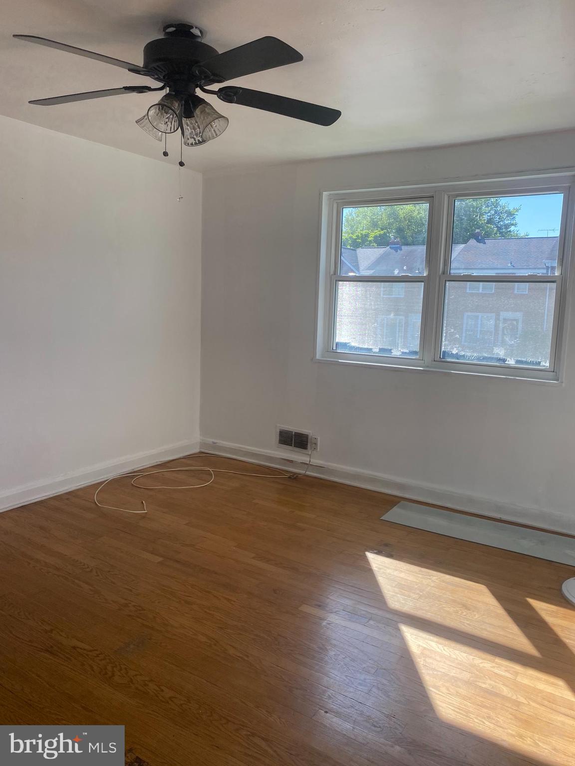 906 Masefield Road Baltimore, MD 21207 - Photo 15 of 22 an empty room with a window and a ceiling fan