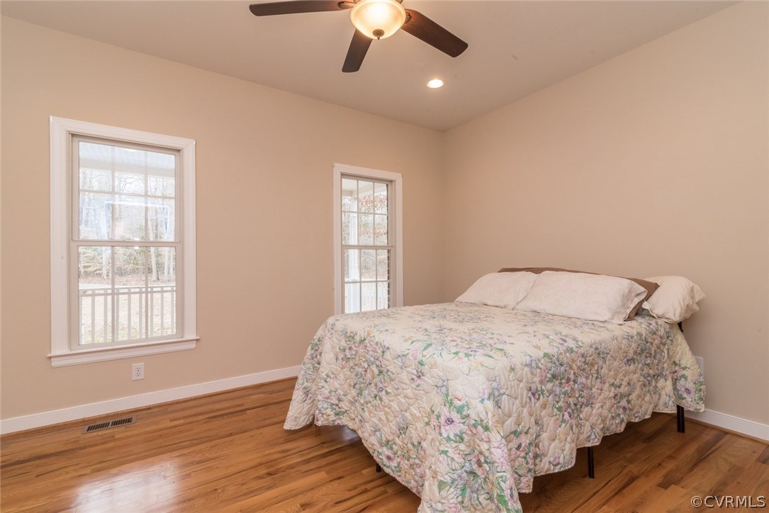20843 Beaver Dam Road Beaverdam, VA 23015 - Photo 24 of 50 a bed sitting in a spacious bedroom next to a window and a chandelier