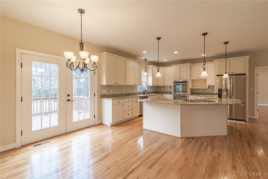 20843 Beaver Dam Road Beaverdam, VA 23015 - Photo 26 of 50 a large kitchen with chandelier and stainless steel appliances