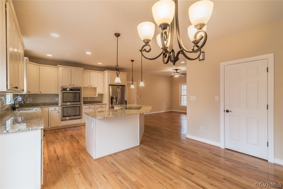 20843 Beaver Dam Road Beaverdam, VA 23015 - Photo 27 of 50 a kitchen with stainless steel appliances granite countertop a sink a oven a stove and a wooden floors
