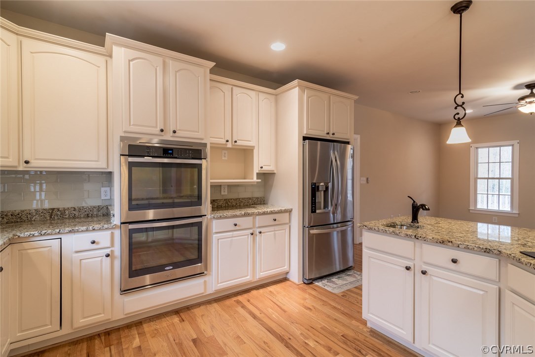 20843 Beaver Dam Road Beaverdam, VA 23015 - Photo 30 of 50 a kitchen with stainless steel appliances granite countertop a refrigerator oven a sink and white cabinets