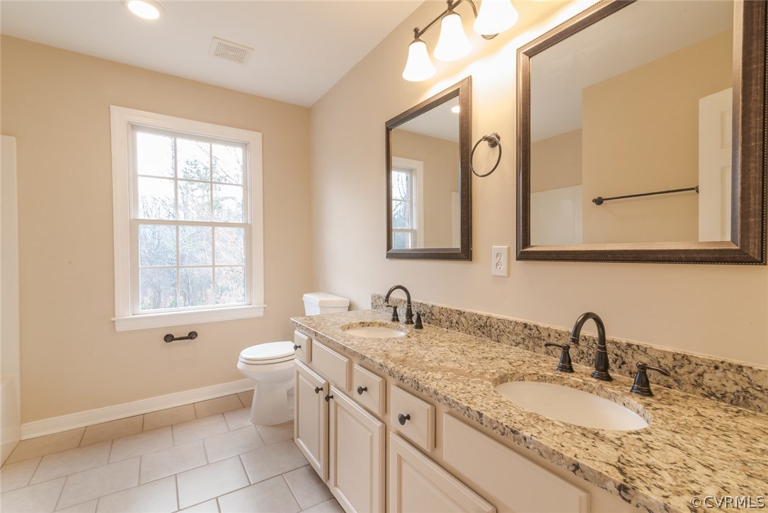 20843 Beaver Dam Road Beaverdam, VA 23015 - Photo 43 of 50 a bathroom with a granite countertop toilet sink and mirror