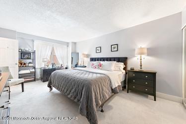 28 Riverside Avenue, Unit 2H Red Bank, NJ 07701 - Photo 17 of 36 a spacious bedroom with a bed and window