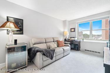 28 Riverside Avenue, Unit 2H Red Bank, NJ 07701 - Photo 19 of 36 a living room with furniture a window and kitchen view
