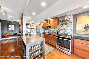 28 Riverside Avenue, Unit 2H Red Bank, NJ 07701 - Photo 5 of 36 a kitchen with stainless steel appliances granite countertop a stove and cabinets