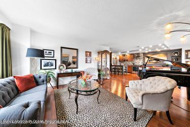 28 Riverside Avenue, Unit 2H Red Bank, NJ 07701 - Photo 8 of 36 a living room with furniture and a table