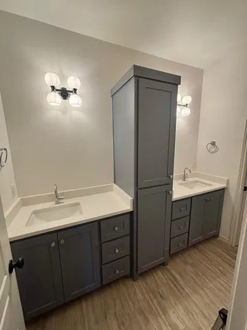 a kitchen with a refrigerator sink and cabinets