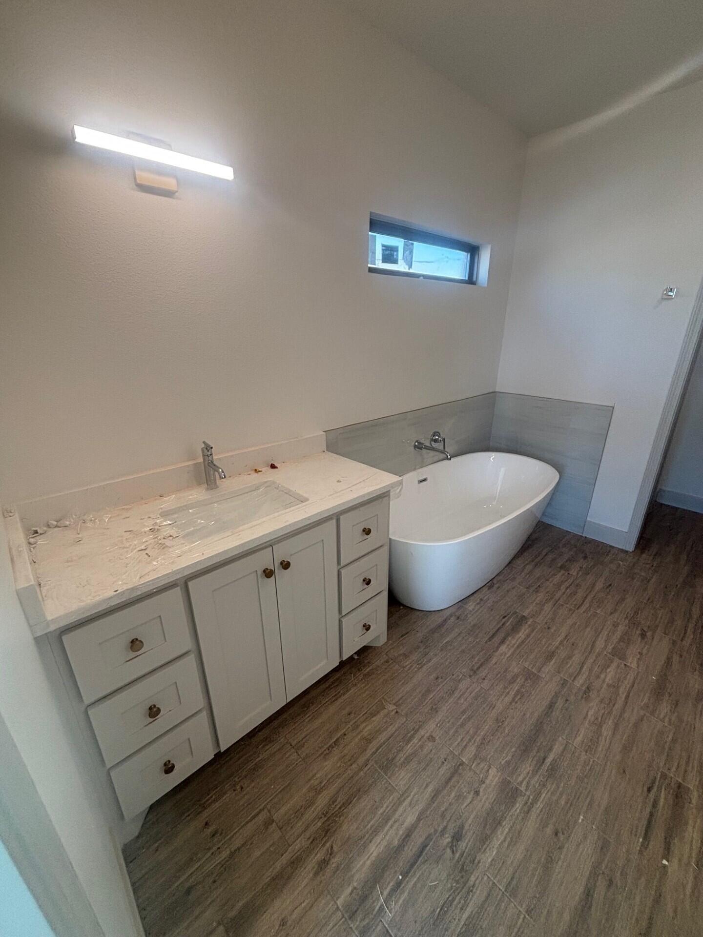 3616 119th Street Lubbock, TX 79423 - Photo 4 of 9 a spacious bathroom with a double vanity sink and a mirror