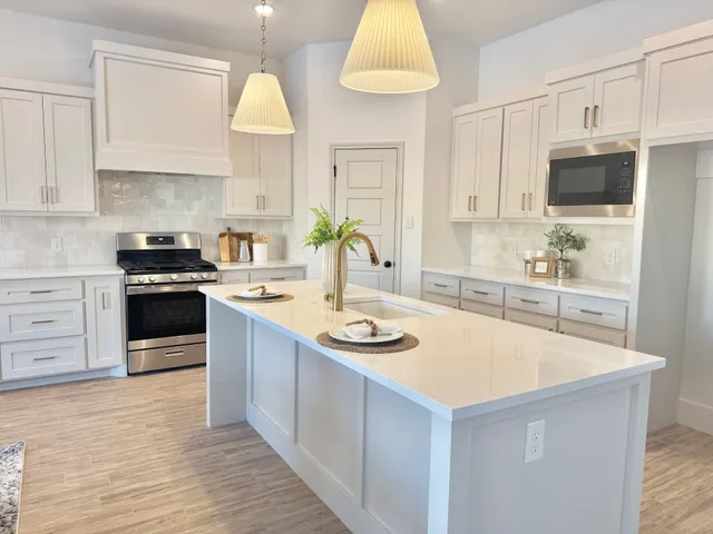 a kitchen with stainless steel appliances a stove sink and cabinets