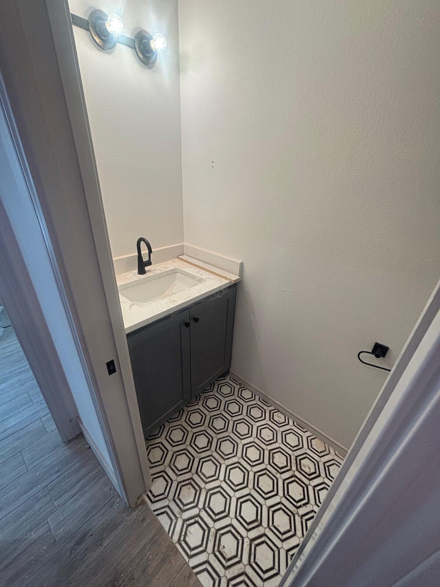 3616 119th Street Lubbock, TX 79423 - Photo 6 of 9 a bathroom with a sink and a mirror