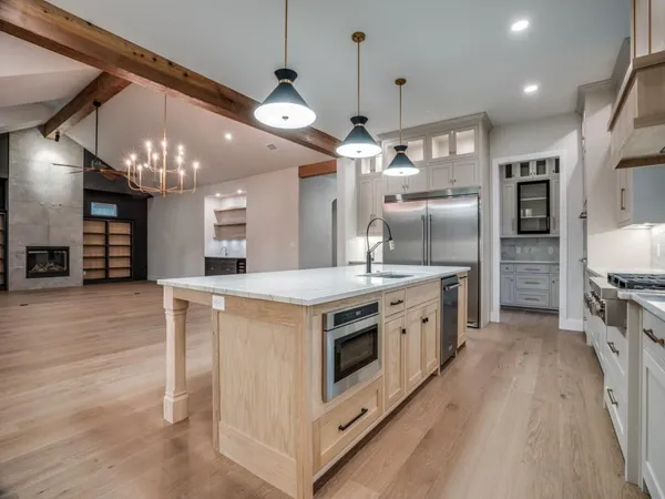 a kitchen with granite countertop a stove and a sink