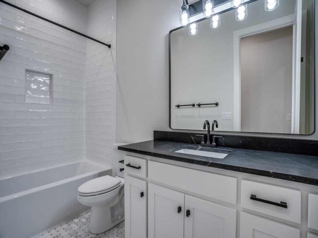 2424 Bellview Circle Tyler, TX 75709 - Photo 24 of 39 a bathroom with a granite countertop sink a toilet and bathtub