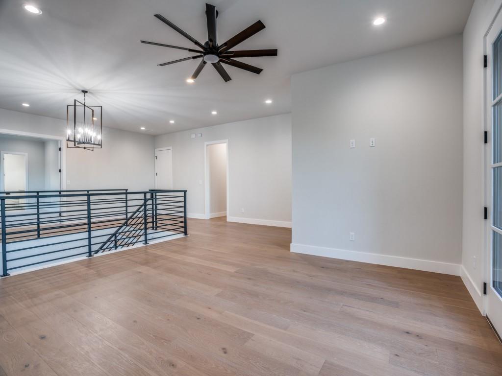 2424 Bellview Circle Tyler, TX 75709 - Photo 27 of 39 an empty room with a ceiling fan and wooden floor