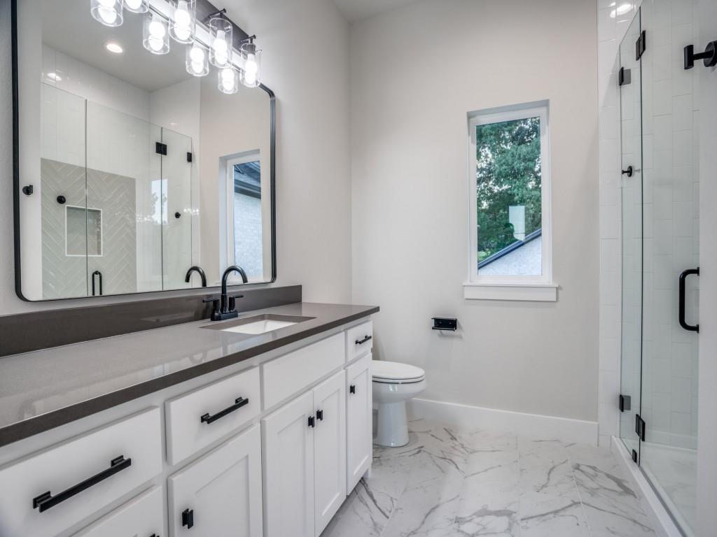 2424 Bellview Circle Tyler, TX 75709 - Photo 31 of 39 a bathroom with a granite countertop sink a toilet and a mirror