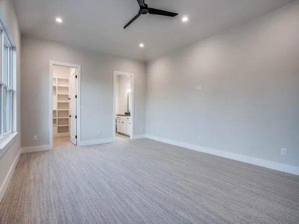 a bathroom with a granite countertop sink mirror and toilet