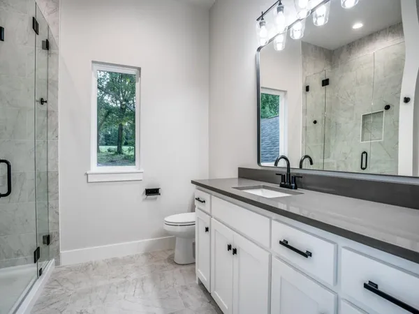 a view of empty room with wooden floor and ceiling fan