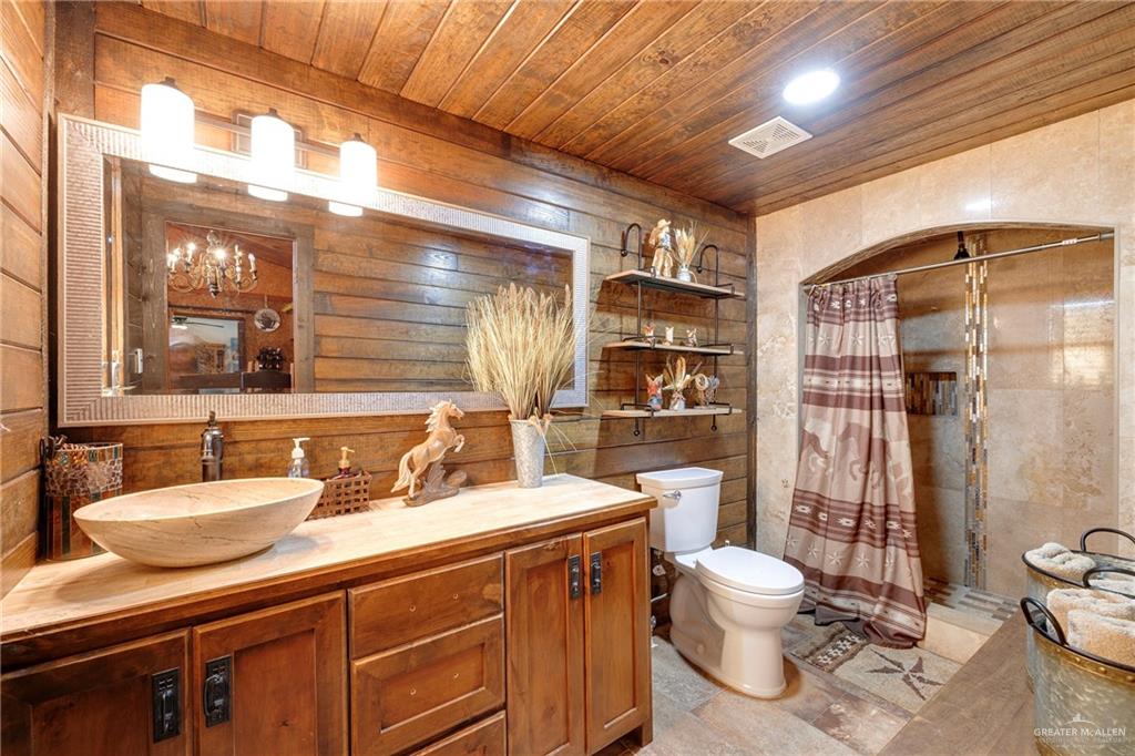 32447 Farm To Market Road 2925 Rio Hondo, TX 78583 - Photo 6 of 25 Bathroom with toilet, a shower with shower curtain, visible vents, vanity, and wood ceiling