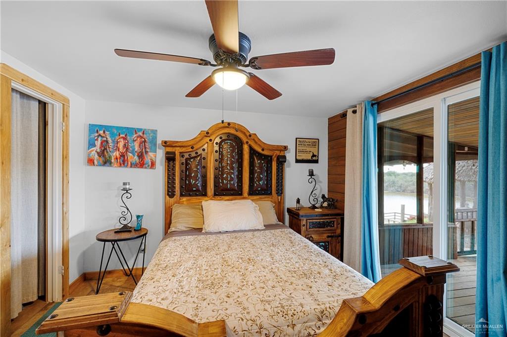 32447 Farm To Market Road 2925 Rio Hondo, TX 78583 - Photo 8 of 25 Bedroom with a ceiling fan, access to outside, baseboards, and wood finished floors