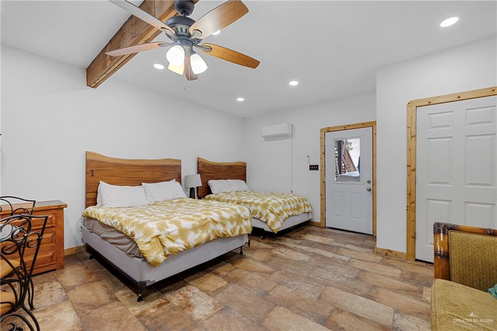 32447 Farm To Market Road 2925 Rio Hondo, TX 78583 - Photo 10 of 25 Bedroom with recessed lighting, baseboards, ceiling fan, stone finish flooring, and a wall mounted AC