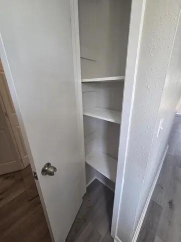 a view of walk in closet with empty racks