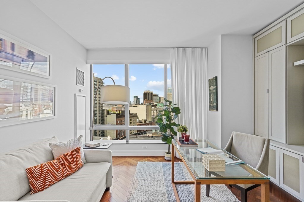 1 Avery Street, Unit U19D Boston, MA 02111 - Photo 14 of 27 a living room with furniture and a large window