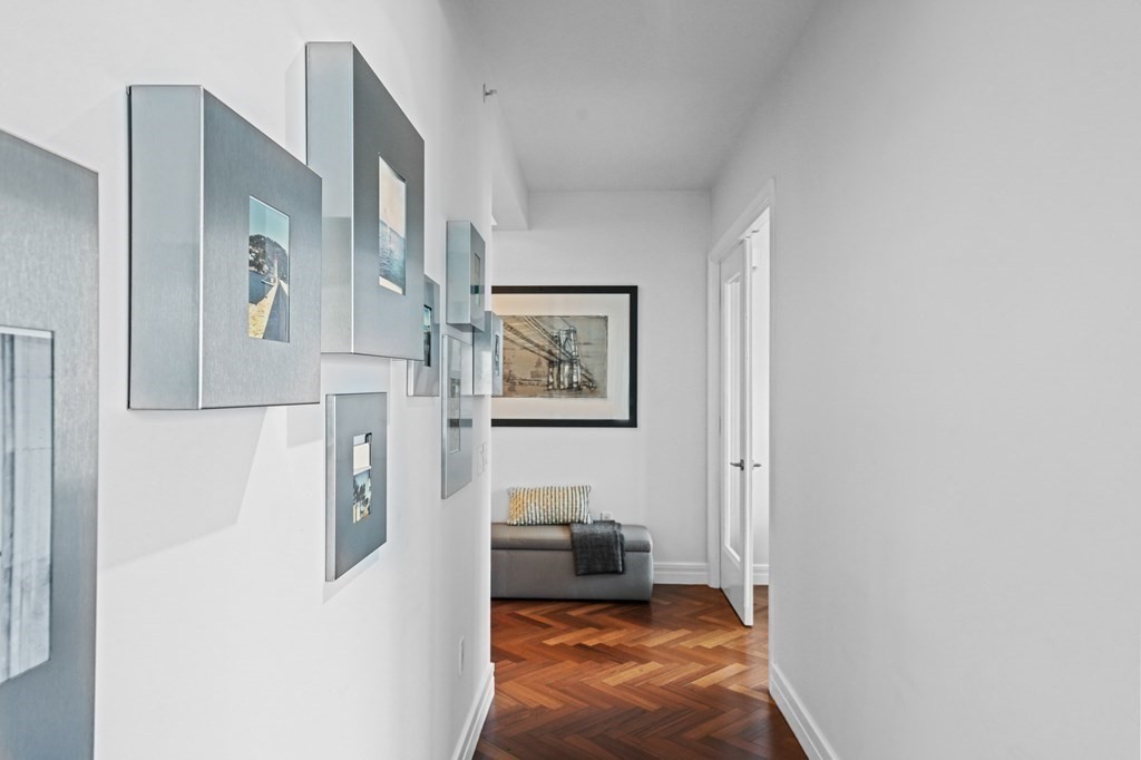 1 Avery Street, Unit U19D Boston, MA 02111 - Photo 16 of 27 a hallway with painting on the wall