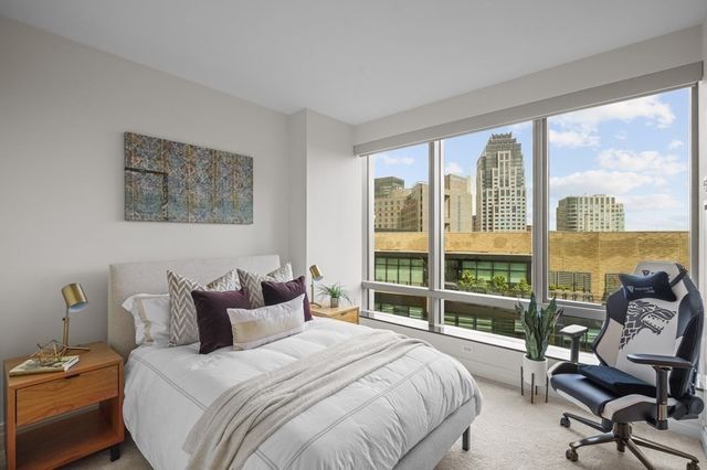 a bedroom with a bed and a large window