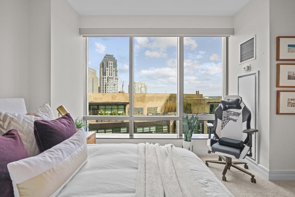1 Avery Street, Unit U19D Boston, MA 02111 - Photo 18 of 27 a living room with furniture and a large window