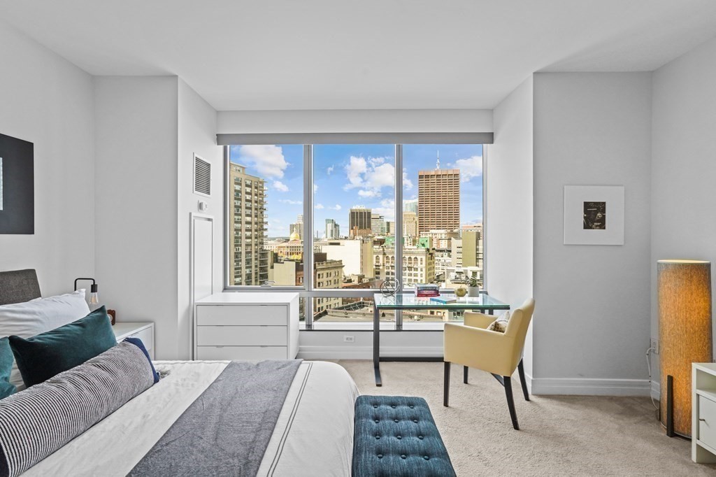 1 Avery Street, Unit U19D Boston, MA 02111 - Photo 23 of 27 a living room with furniture and a floor to ceiling window