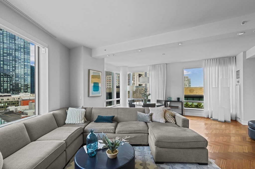 1 Avery Street, Unit U19D Boston, MA 02111 - Photo 5 of 27 a living room with furniture and a large window