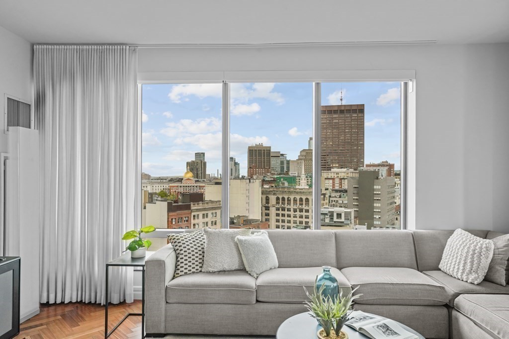 1 Avery Street, Unit U19D Boston, MA 02111 - Photo 6 of 27 a living room with furniture and a large window