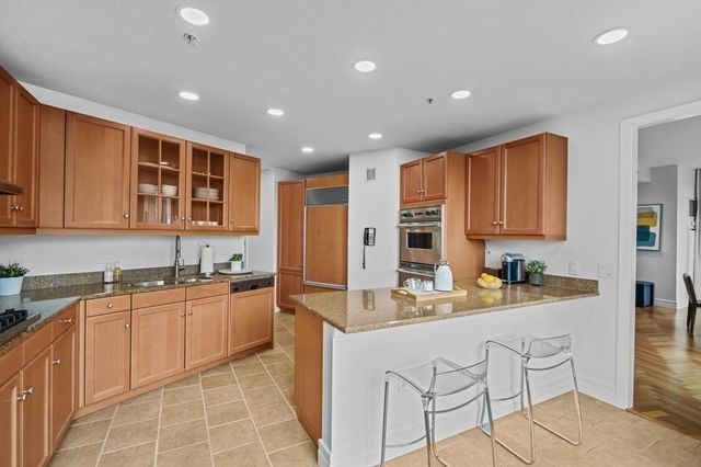 a kitchen with stainless steel appliances granite countertop a sink and cabinets