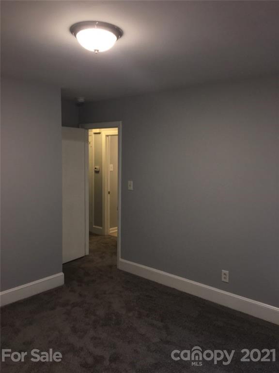 3633 Kempton Place Charlotte, NC 28208 - Photo 19 of 32 an empty room with wooden floor and windows