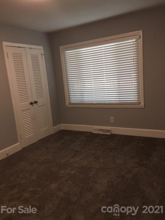 3633 Kempton Place Charlotte, NC 28208 - Photo 21 of 32 a view of an empty room with wooden floor and a window