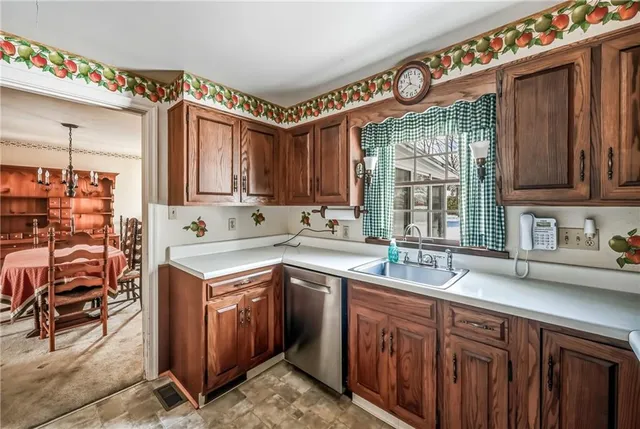 a kitchen that has a sink and a stove in it