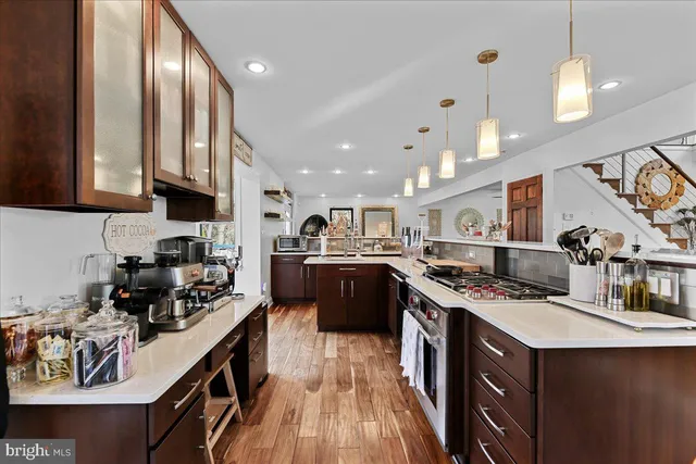 a large kitchen with stainless steel appliances lots of counter top space